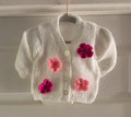 Knitted white cardigan, adorned with crochet flowers