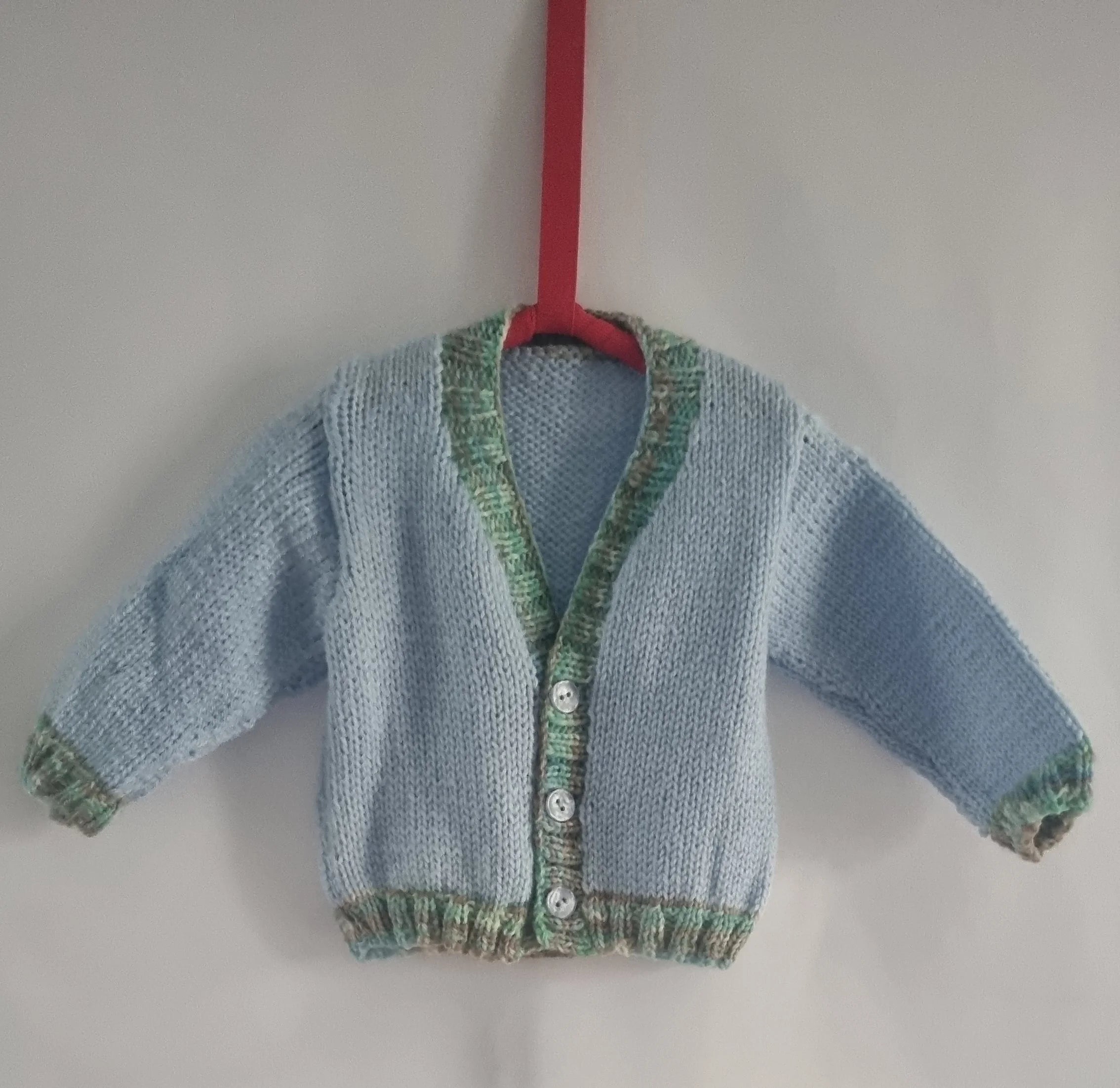 Hand knitted 6-12 months baby boys cardigan, baby blue and green edging