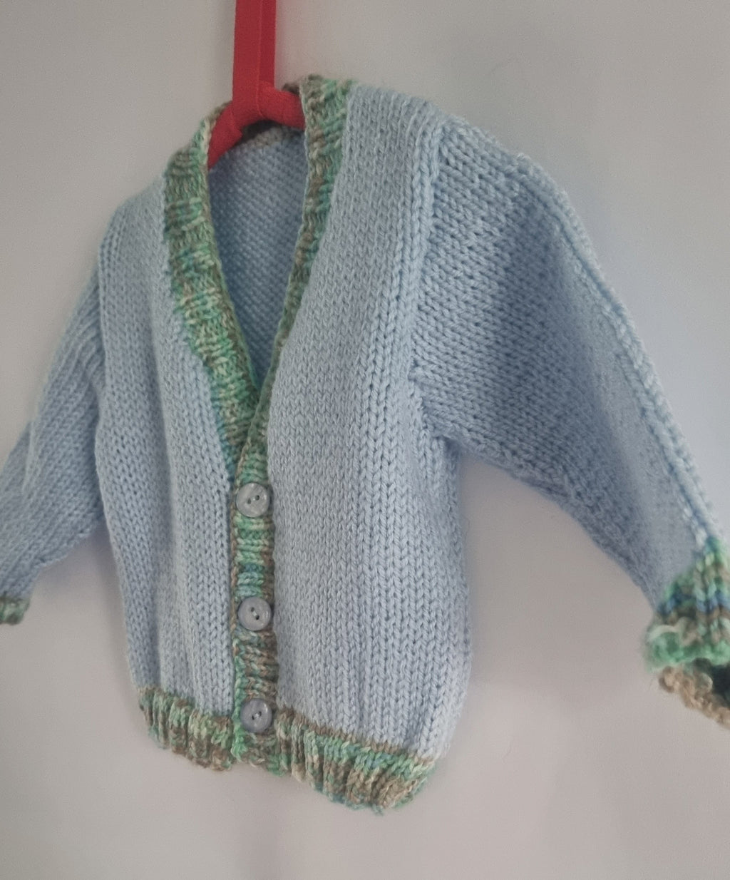 Hand knitted 6-12 months baby boys cardigan, baby blue and green edging