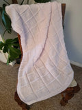 Hand knitted pastel pink baby blanket
