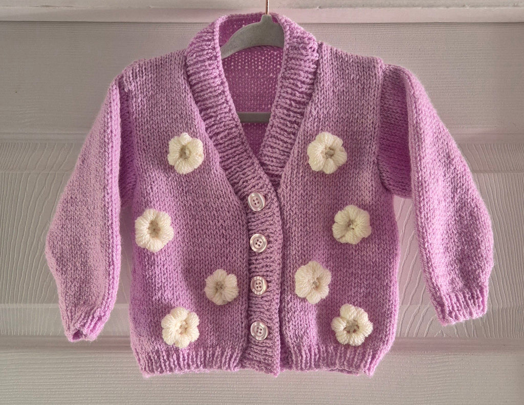 Pink cardigan with crochet flowers