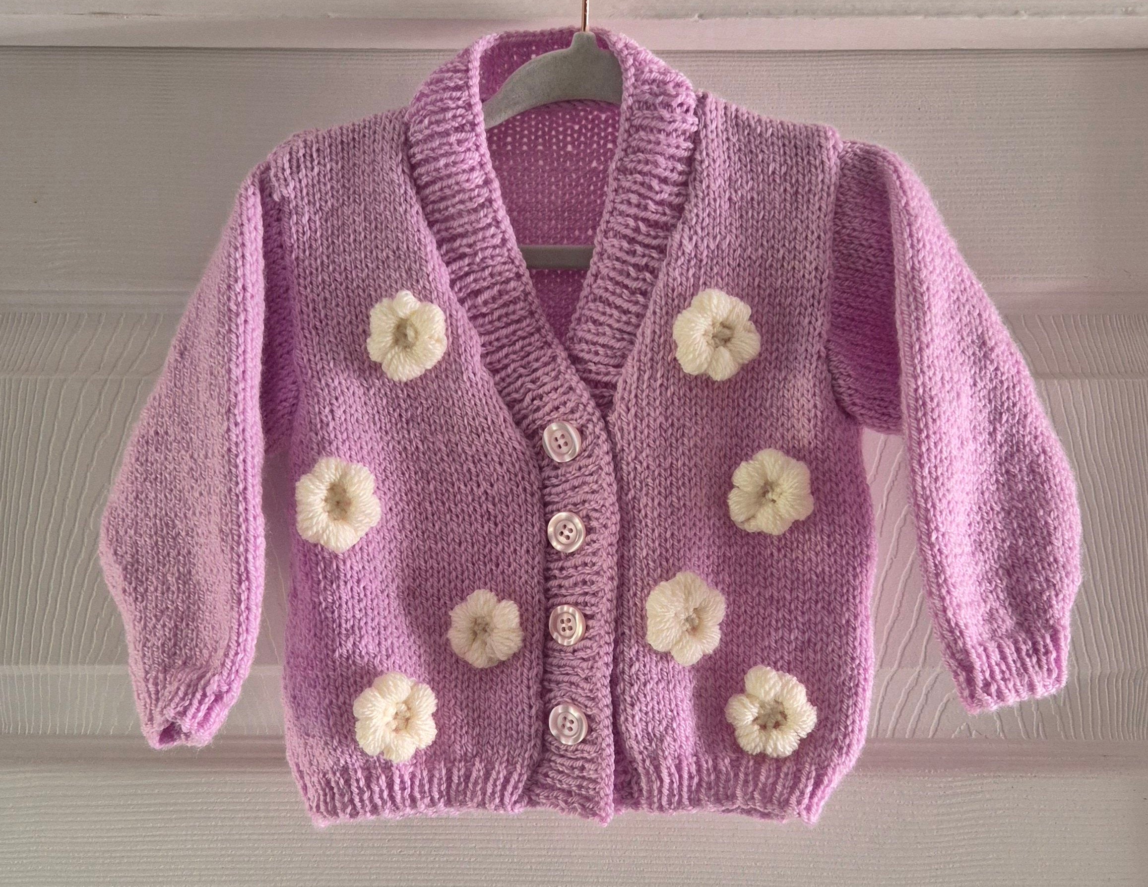 Pink cardigan with crochet flowers