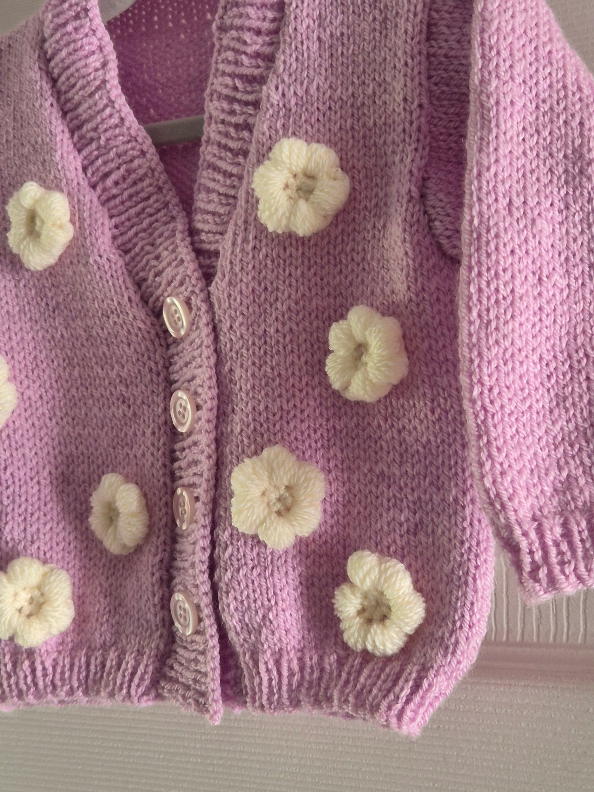 Pink cardigan with crochet flowers