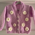 Pink cardigan with crochet flowers