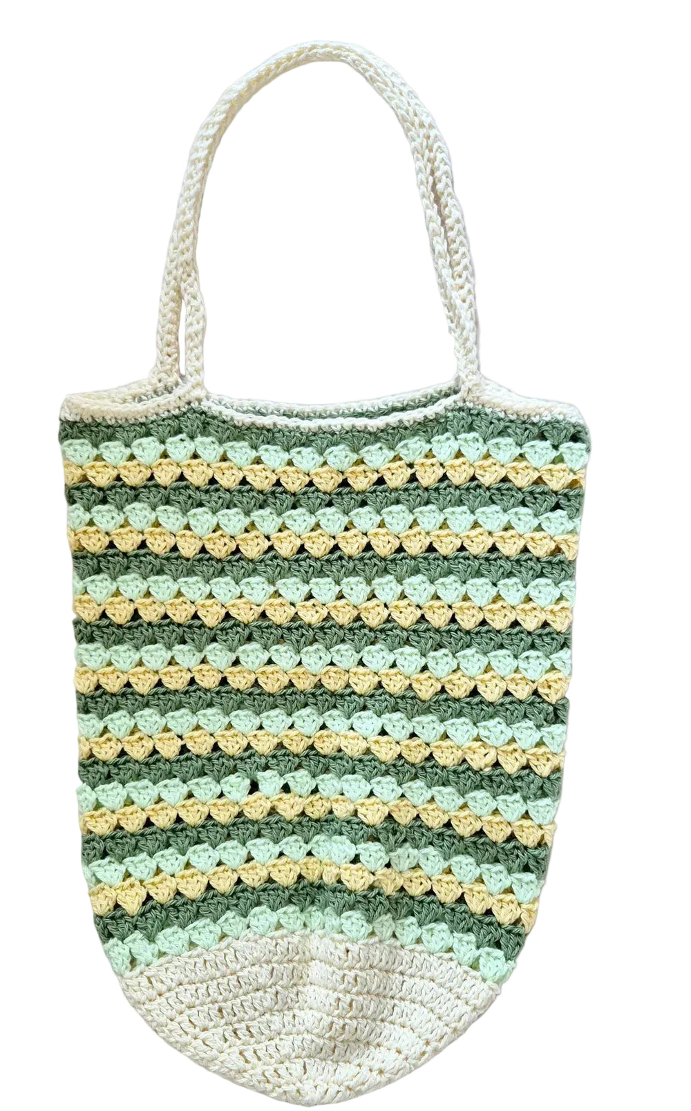 A handmade crocheted tote bag with horizontal stripes of sage green, light green, and pale yellow, featuring cream-colored handles and bottom trim, laid flat on a textured white blanket.